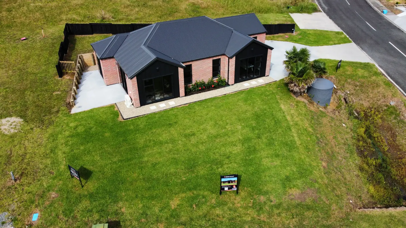 Aerial view of a Northland home with a large, freshly laid kikuyu lawn wrapping around the house and down to the street